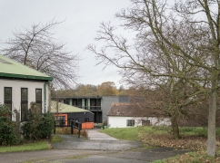 Image of Wysing's site, showing the Top Barn and Window Room to the left, and the new Studio Block in the distance.